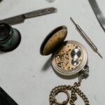 Detailed view of a vintage pocket watch with repair tools, showcasing precision craftsmanship.
